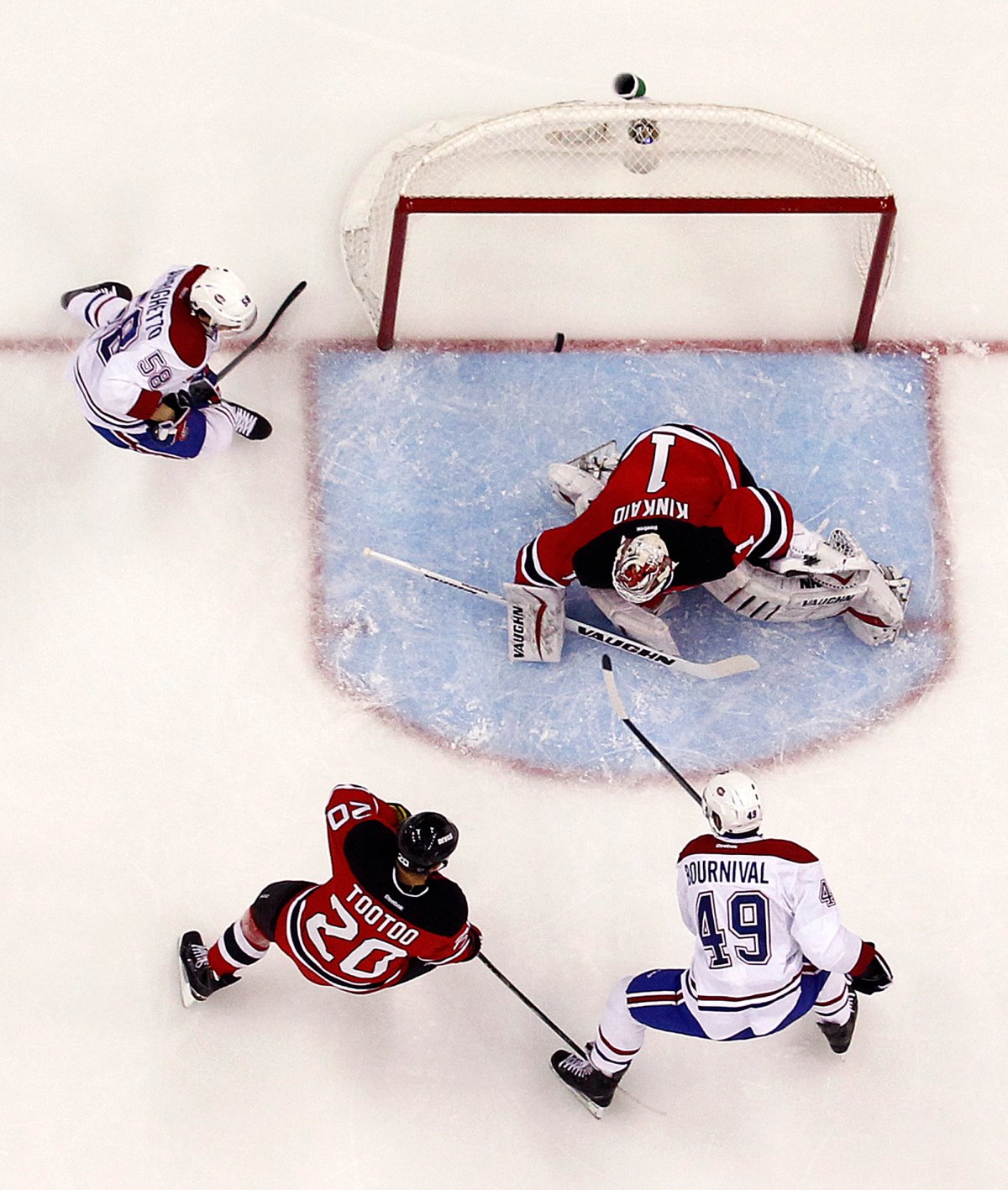 Montreal Canadiens left wing Michael Bournival (49) scores a goal on New Jersey Devils goalkeeper Keith Kinkaid (1) during the third period of an NHL hockey game, Friday, Jan. 2, 2015, in Newark, N.J.