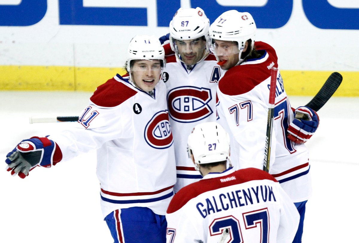 Montreal Canadiens' Max Pacioretty, center, is congratulated by Brendan Gallagher (11) and Tom Gilbert (77) after scoring a goal against the Pittsburgh Penguins during the first period of an NHL hockey game in Pittsburgh, Saturday, Jan. 3, 2015.