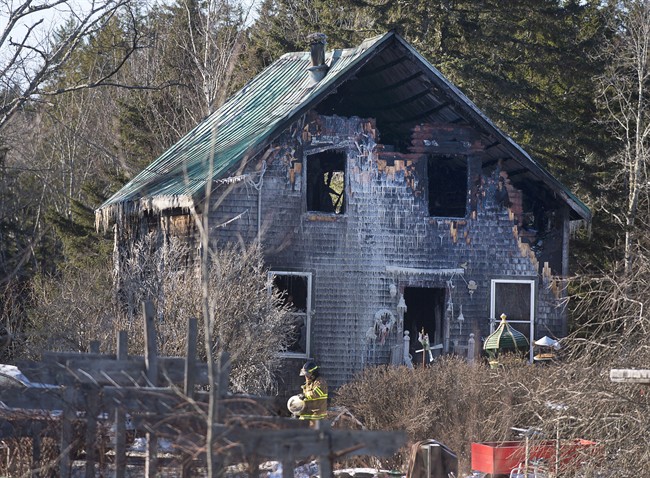 A firefighter works at the scene of a fatal house fire near Wyses Corner, N.S., outside of Halifax, on Thursday, Jan. 8, 2015. 