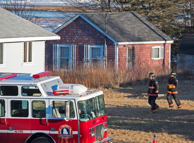 Firefighters attend the scene where a large quantity of unidentified chemicals were found in a residence in Grand Desert, N.S. on Jan. 21, 2015.