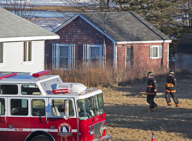 Firefighters attend the scene where a large quantity of unidentified chemicals were found in a residence in Grand Desert, N.S. on Jan. 21, 2015.