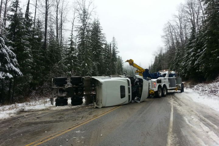 Crews tend to a trailer tractor that lost control on Highway 1 three kilometres west of Three Valley Gap on November 22, 2014. 