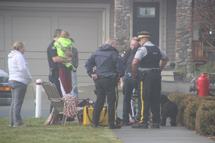Crews tend to a two year old girl rescued from a house fire in the 19000 block of 71st Avenue in Surrey.