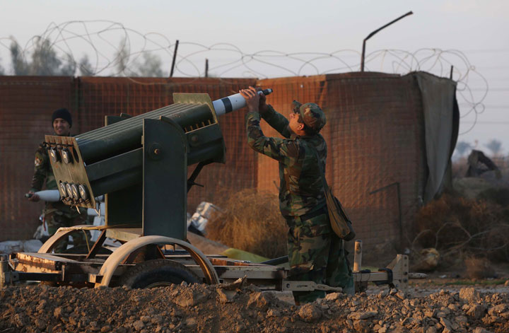 An Iraqi soldier loads a multiple rocket launcher during clashes between Islamic State group fighters and a coalition of combatants made up of the Iraqi army and pro-government fighters including the Al-Abbas Fighting Division on January 2, 2015. 