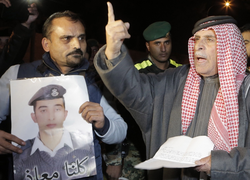 Safi al-Kassasbeh, the father of Jordanian pilot Maaz al-Kassasbeh (portrait), who was captured by Islamic State (IS) group militants on December 24 after his F-16 jet crashed while on a mission against the jihadists over northern Syria, protests outside the Royal court in Amman on January 28, 2015. 