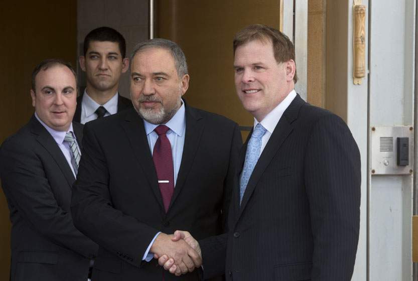 Israeli Foreign Minister Avigdor Lieberman shakes hands with his Canadian counterpart John Baird during their meeting in Jerusalem, Sunday, Jan. 18, 2015.