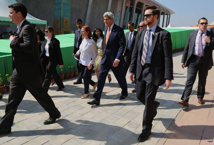 U.S. Secretary of State John Kerry walks out of the Vibrant Gujarat summit in Gandhinagar, India, Monday Jan. 12, 2015. 