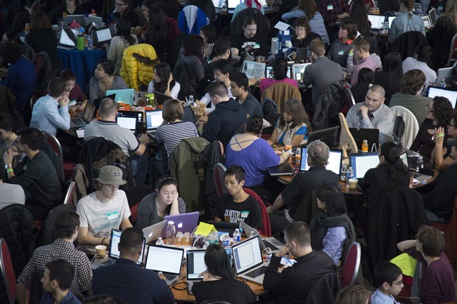 Participants jam into a giant lecture hall in Vancouver, B.C. Saturday, Jan. 24, 2015 to take part in HTML500, a course which teaches computer coding skills. 