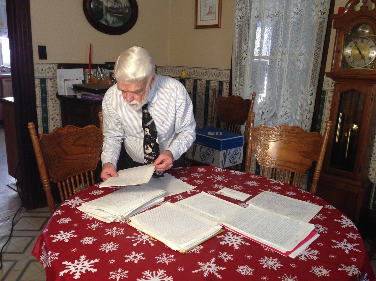 Retired teacher Bruce Farrer sorts through student letters he's stored for 20 years. 