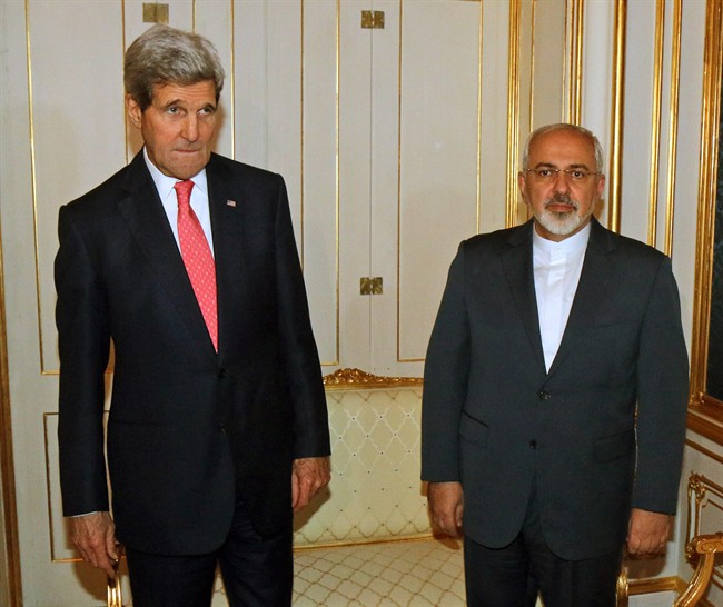 In this Nov. 23, 2014 file photo, U.S. Secretary of State John Kerry and Iranian Foreign Minister Mohammad Javad Zarif, right, pose for a photograph prior to a bilateral meeting of the closed-door nuclear talks in Vienna, Austria. 