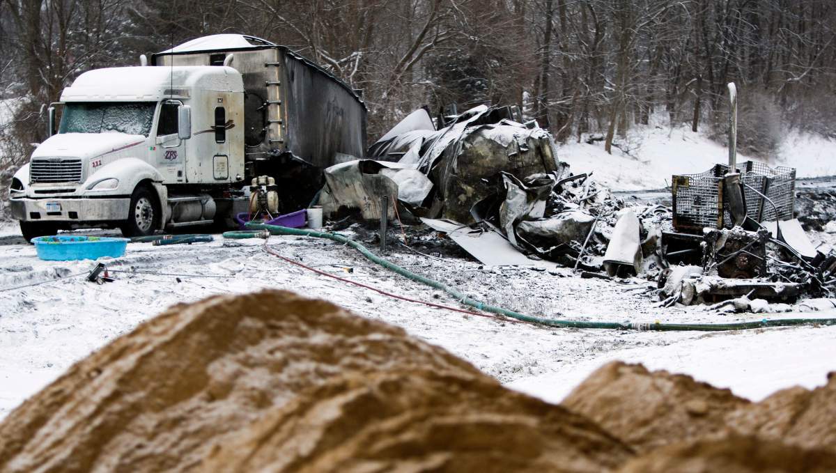 The charred remains of vehicles and debris sit on Interstate 94, Saturday, Jan. 10, 0215, as road crews work to clear them the day after a series of crashes closed the highway between mile markers 88 and 92 in eastern Kalamazoo County, near Galesburg, Mich.