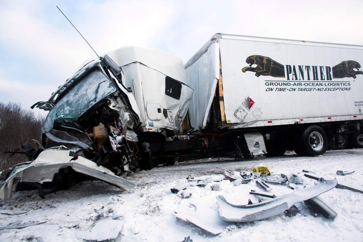 Road crews work to clear wrecked vehicles and debris along Interstate 94, Saturday, Jan. 10, 0215, the day after a series of crashes closed the highway between mile markers 88 and 92 in eastern Kalamazoo County, near Galesburg, Mich.