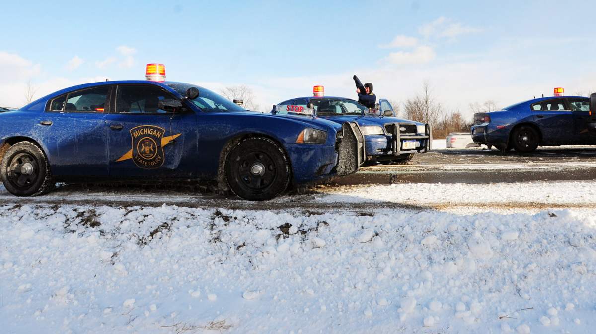 Police on U.S. 23 respond after a massive pile up in York Township, Mich. Friday, Jan. 9, 2015.