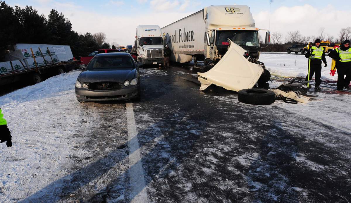 Michigan State Police investigate a massive pile up on U.S. 23 in York Township, Mich. Friday, Jan. 9, 2015.