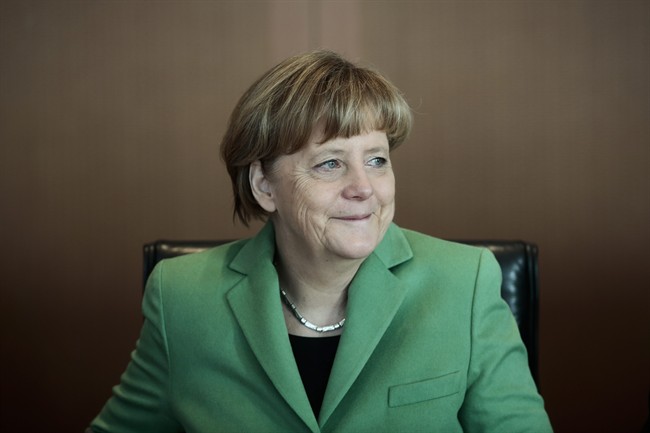 German Chancellor Angela Merkel smiles at the beginning of the weekly cabinet meeting of her government at the chancellery in Berlin, Wednesday, Jan. 28, 2015.