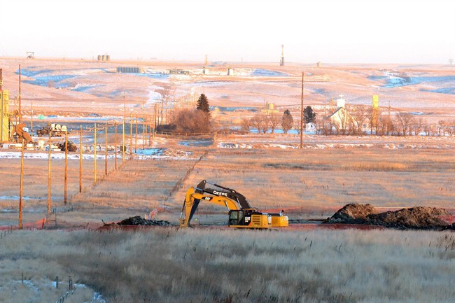 In this photo taken Jan. 12, 2015, crews dig up land at a saltwater spill site near Blacktail Creek outside Williston, N.D.  (AP Photo/Williston Herald, Zack Nelson).