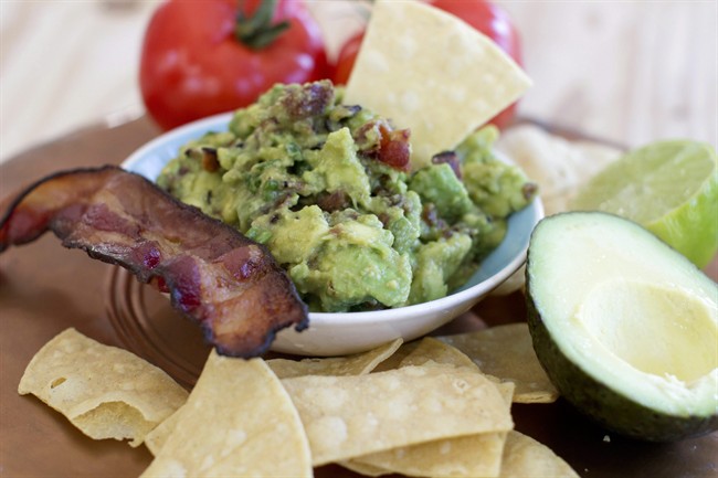 This Dec. 15, 2014 photo shows maple bacon guacamole in Concord, N.H. There are multiple ways to serve up guacamole for the Super Bowl.