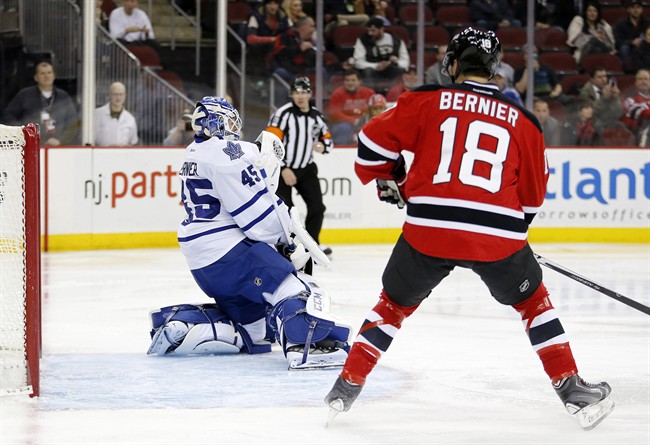Toronto Maple Leafs goalie Jonathan Bernier (45) makes a save on a shot by the New Jersey Devils as right wing Steve Bernier (18) watches during the second period of an NHL hockey game, Wednesday, Jan. 28, 2015, in Newark, N.J. 