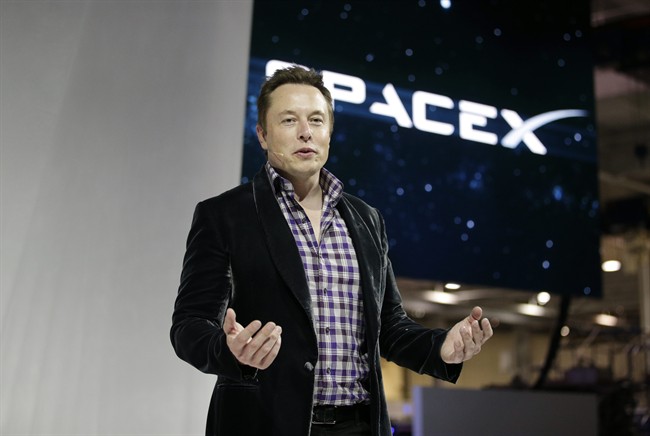 Elon Musk, CEO and CTO of SpaceX, introduces the SpaceX Dragon V2 spaceship at the SpaceX headquarters in Hawthorne, Calif. SpaceX said it has raised $1 billion and added Google Inc. and Fidelity as investors.