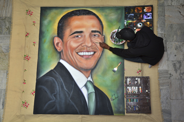 Indian artist Jagjot Singh Rubal gives final touches on a painting of U.S. President Barack Obama in Amritsar, India, Friday, Jan. 23, 2015. 