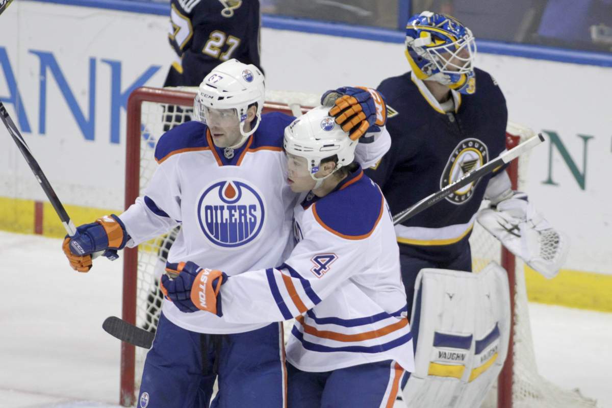 Edmonton Oilers’ Benoit Pouliot (67) is congratulated by teammate Taylor Hall (4) after he scored a goal, as St. Louis Blues goalie Jake Allen (34) regroups, in the third period of a NHL hockey game, Tuesday, Jan. 13, 2015 in St. Louis. The Blues beat the Oilers 4-2.