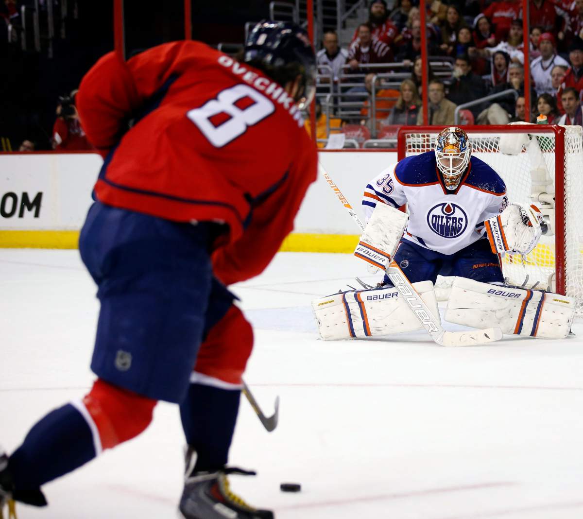 Washington Capitals left wing Alex Ovechkin (8), from Russia, shoots the puck against Edmonton Oilers goalie Viktor Fasth (35), from Sweden, who defects the puck, in the second period of an NHL hockey game, Tuesday, Jan. 20, 2015, in Washington.