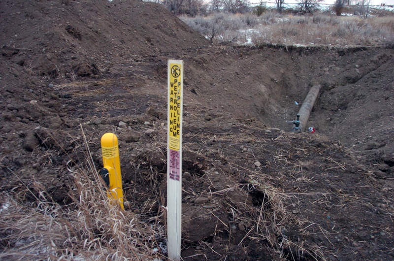 A warning sign shows the location of a 12-inch oil pipeline owned by Bridger Pipeline Co. that spilled up to 50,000 gallons of crude along the Yellowstone River near Glendive, Mont., Monday, Jan. 19, 2015. 