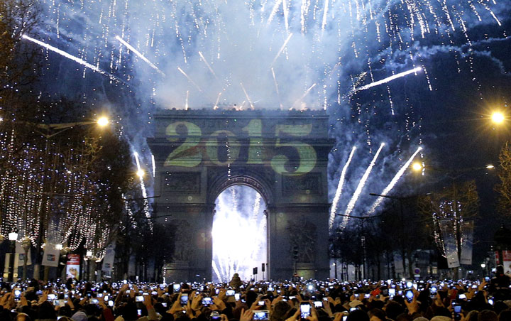 Revelers celebrate New Year's Eve on the Champs Elysees avenue in Paris, France, Thursday, Jan. 1, 2015.