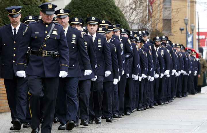 New York City police officers march before funeral services for police officer Wenjian Liu on Sunday, Jan. 4, 2015, in the Brooklyn borough of New York.