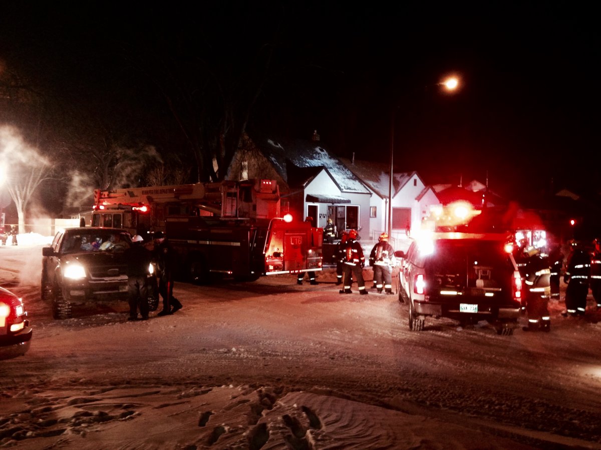 Fire crews battle a fire in the basement of this home on Polson Avenue Saturday evening.
