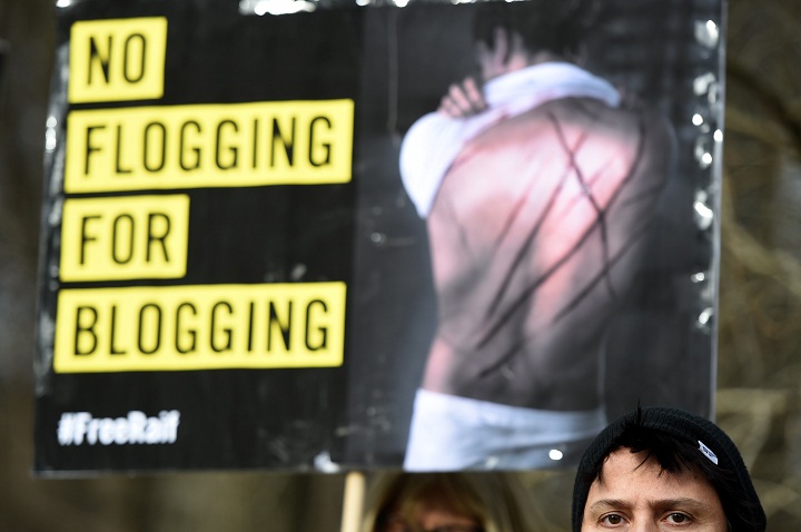 Amnesty International activists protest with a placard reading 'No flogging for blogging' against the flogging punishment of Saudi blogger Raif Badawi on January 29, 2015.