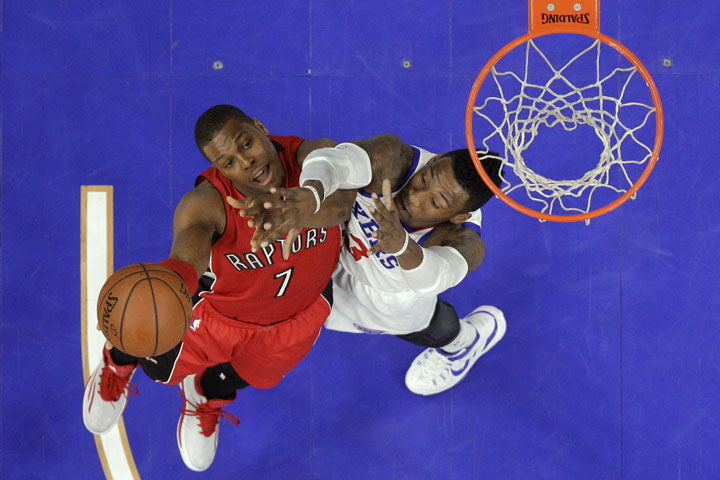 Toronto Raptors' Kyle Lowry, left, tries to get a shot past Philadelphia 76ers' Robert Covington during the first half of an NBA basketball game, Friday, Jan. 23, 2015, in Philadelphia. 