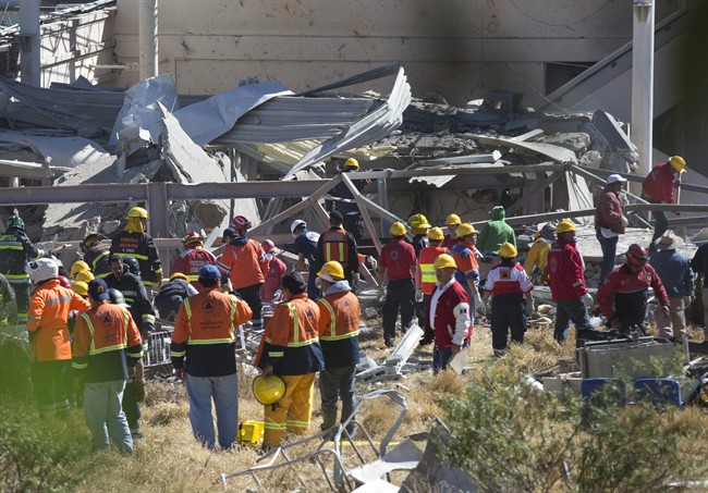 Rescue workers search for survivors in the rubble of a maternity and children's hospital that was shattered by a gas tank truck explosion in Cuajimalpa on the outskirts of Mexico City, Thursday, Jan. 29, 2015.
