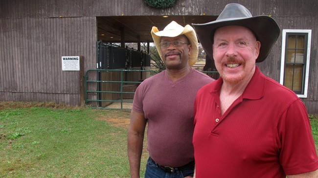 In this photo taken on Monday, Dec. 29, 2014, Ozzie Russ, left and his partner Steve Schlariet, plaintiffs in the case that led to a federal judge ruling Florida's gay marriage ban is unconstitutional, pose at their ranch in Chipley, Fla.