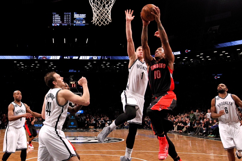 Toronto Raptors' DeMar DeRozan (10) goes to the basket against Brooklyn Nets' Mason Plumlee (1) during the overtime period of an NBA basketball game Friday, Jan. 30, 2015, in New York. Toronto defeated Brooklyn 127-122.