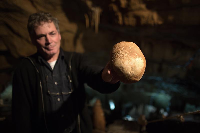 Israeli Professor Hershkowitz shows part of a 55,000 year old partial skull found in the Dan David-Manot Cave in Israel's Western Galilee, near the settlement of Manot, on January 28, 2015.