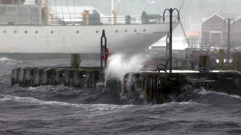 Waves crash up and onto the Halifax boardwalk during a storm surge. (March 24, 2014).
