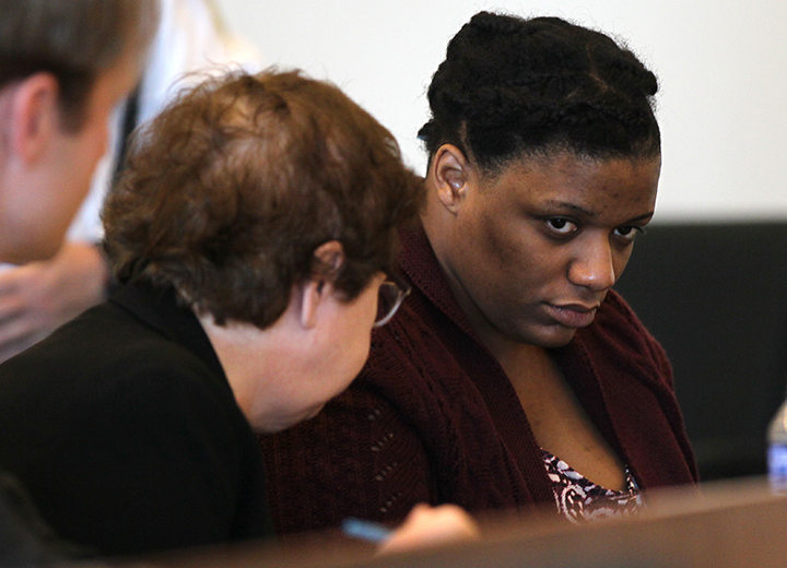 Tanicia Goodwin, right, sits with defense lawyer Denise Regan inside Salem Superior Court, Friday, Jan. 2, 2015, in Salem, Mass.