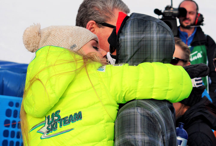 Tiger Woods and Lindsey Vonn, left, exchange a kiss in the finish area of an alpine ski, women’s World Cup super-G, in Cortina d’Ampezzo, Italy, Monday, Jan. 19, 2015.