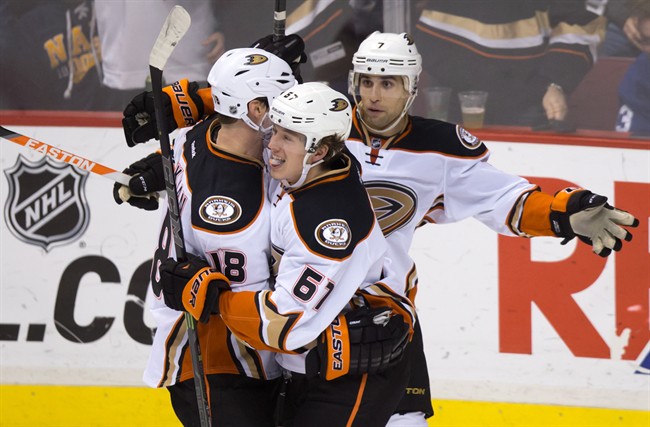 Anaheim Ducks' Tim Jackman, from left to right, Rickard Rakell, of Sweden, and Andrew Cogliano celebrate Rakell's goal against the Vancouver Canucks during the third period of an NHL hockey game in Vancouver, B.C., on Tuesday January 27, 2015.