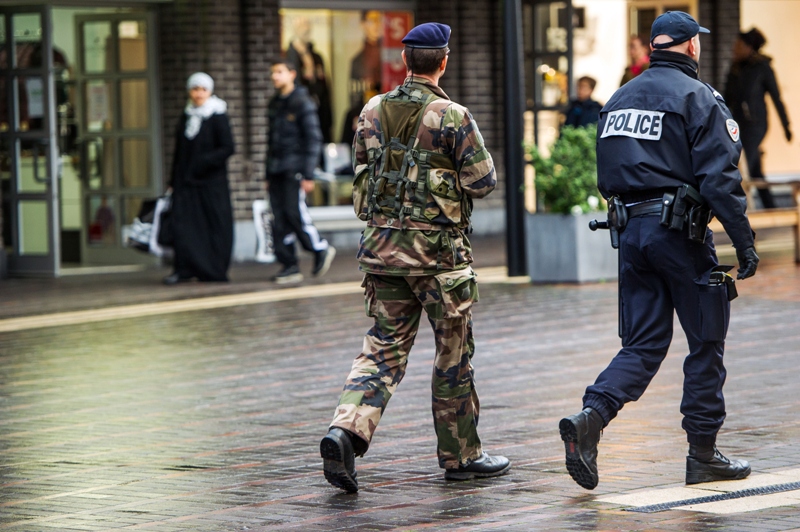 A French police officer and a soldier patrol in a street of Roubaix, northern France, on January 13, 2015.