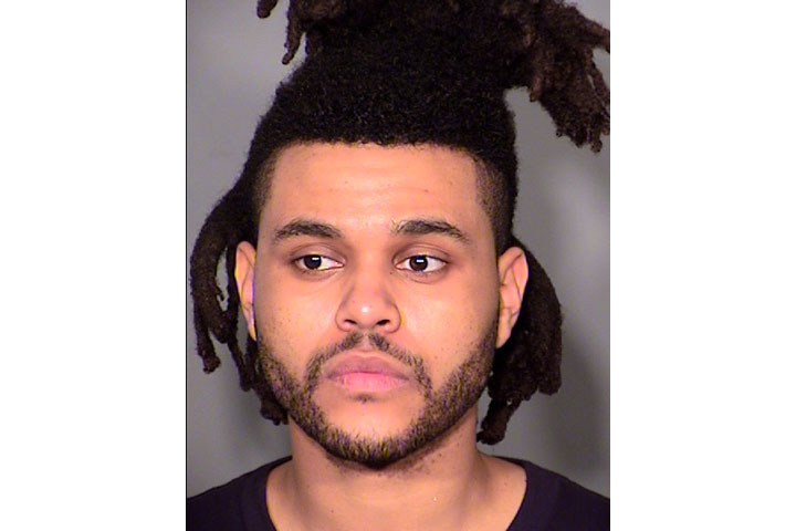 The Weeknd, pictured in a police booking photo.