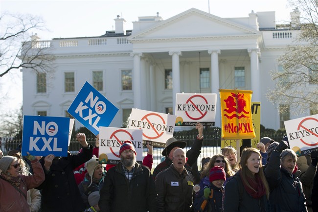 Demonstrators stand in front of the White House during a rally in support of President Barack Obama's pledge to veto any legislation approving the Keystone XL pipeline.