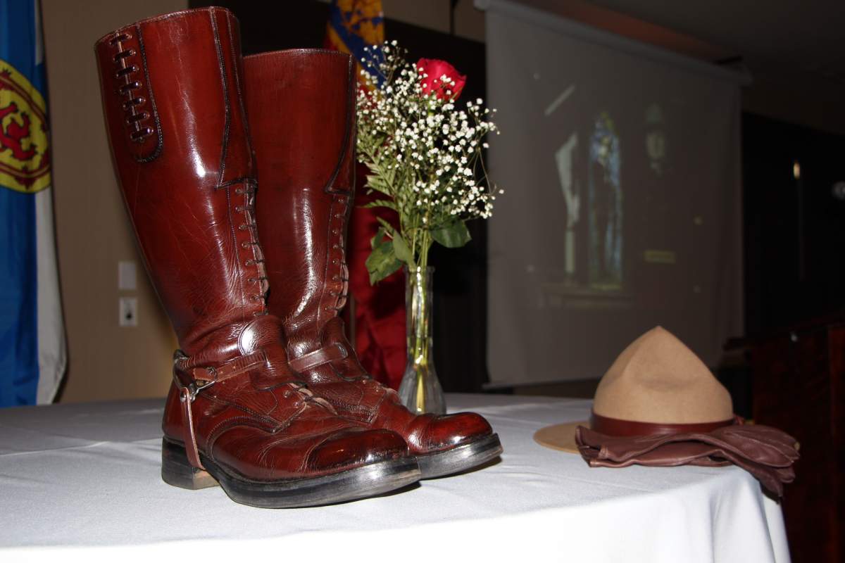 RCMP boots and a stetson sit on a table for a memorial to RCMP Const. David Wynn.