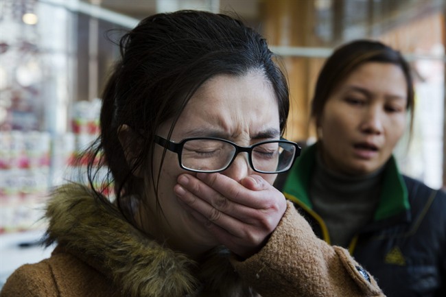 Li Juan holds back tears as she recall the night her sister Li Na was killed in a deadly stampede in Shanghai, China, Friday, Jan. 2, 2015. 