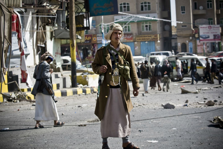 Houthi Shiite Yemeni gather while guarding a street leading to the presidential palace in Sanaa, Yemen, on Tuesday.