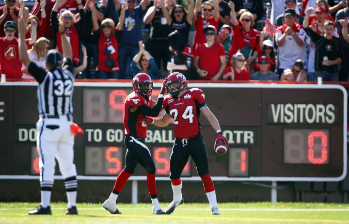 New Rider Keenan MacDougall, right, celebrates his interception touchdown with teammate Quincy Butler during first half CFL football action against the Montreal Alouettes in Calgary, Alta., Sunday, July 1, 2012. 