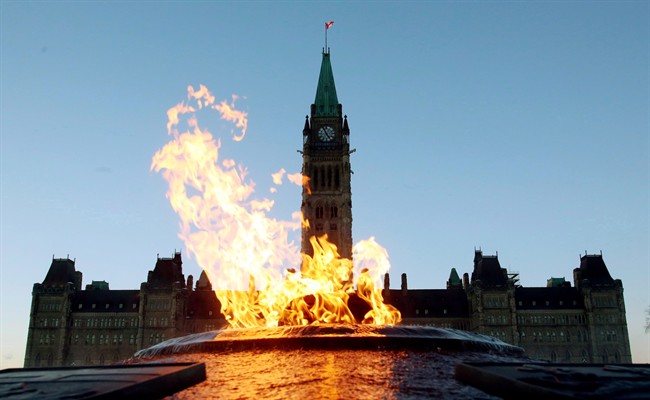 The Centre Block of the Parliament Buildings is shown through the Centennial Flame on Parliament Hill in Ottawa on Sunday, January 25, 2015.