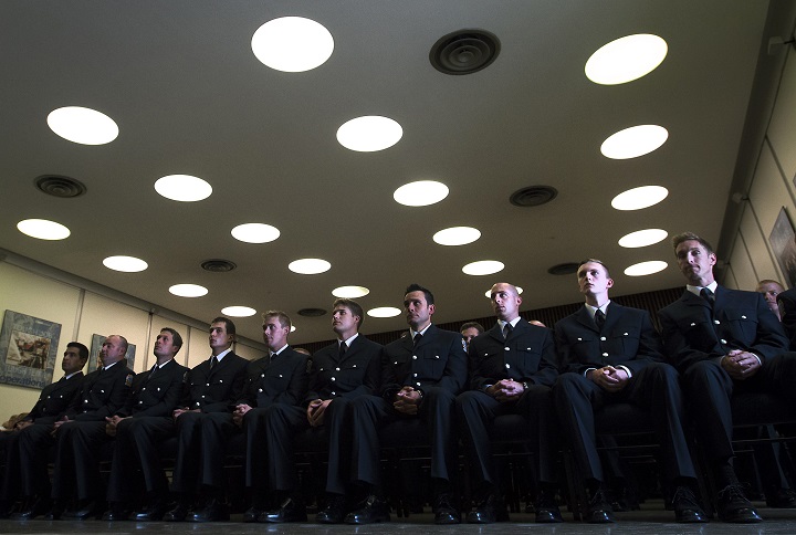 Firefighter graduates march in unison after receiving their badge and certificates during a graduation ceremony at the Toronto Fire/EMS Training Centre in Toronto on Thursday, July 31, 2014. 