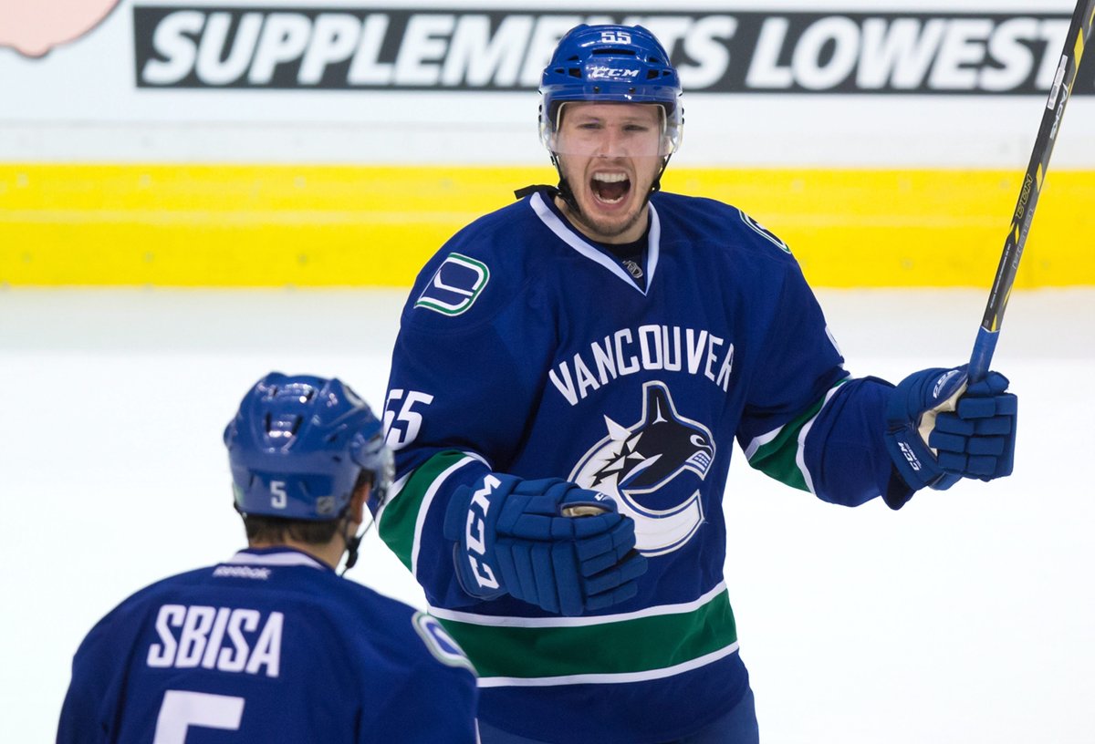 Vancouver Canucks' Alex Biega, right, and Luca Sbisa celebrate Biega's first NHL goal during the third period. 